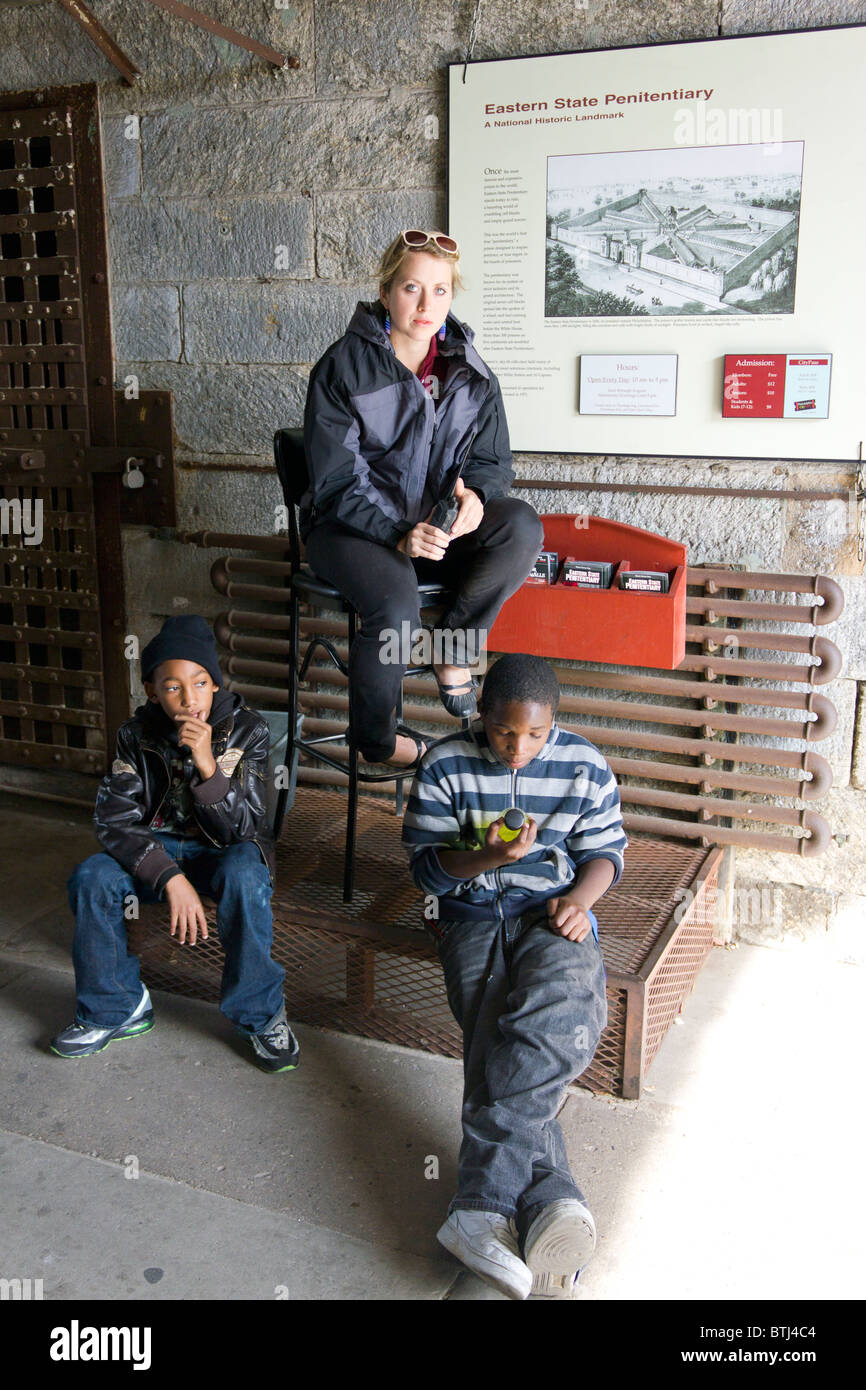 white guard with two black local children, Eastern State Penitentiary (ESP), Philadelphia, Pennsylvania, USA Stock Photo