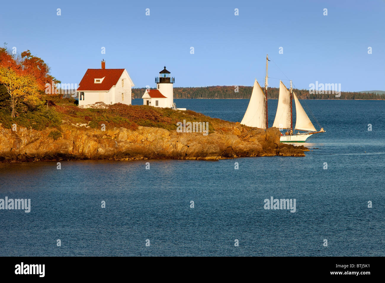 Schooner sailing past Curtis Island Lighthouse in Camden Maine USA Stock Photo