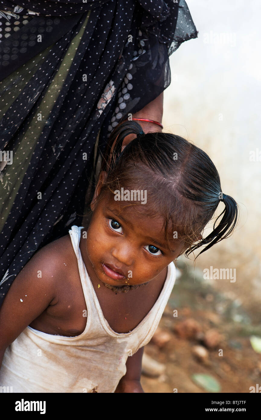 Poor indian baby girl with mother on the street in India. Selective