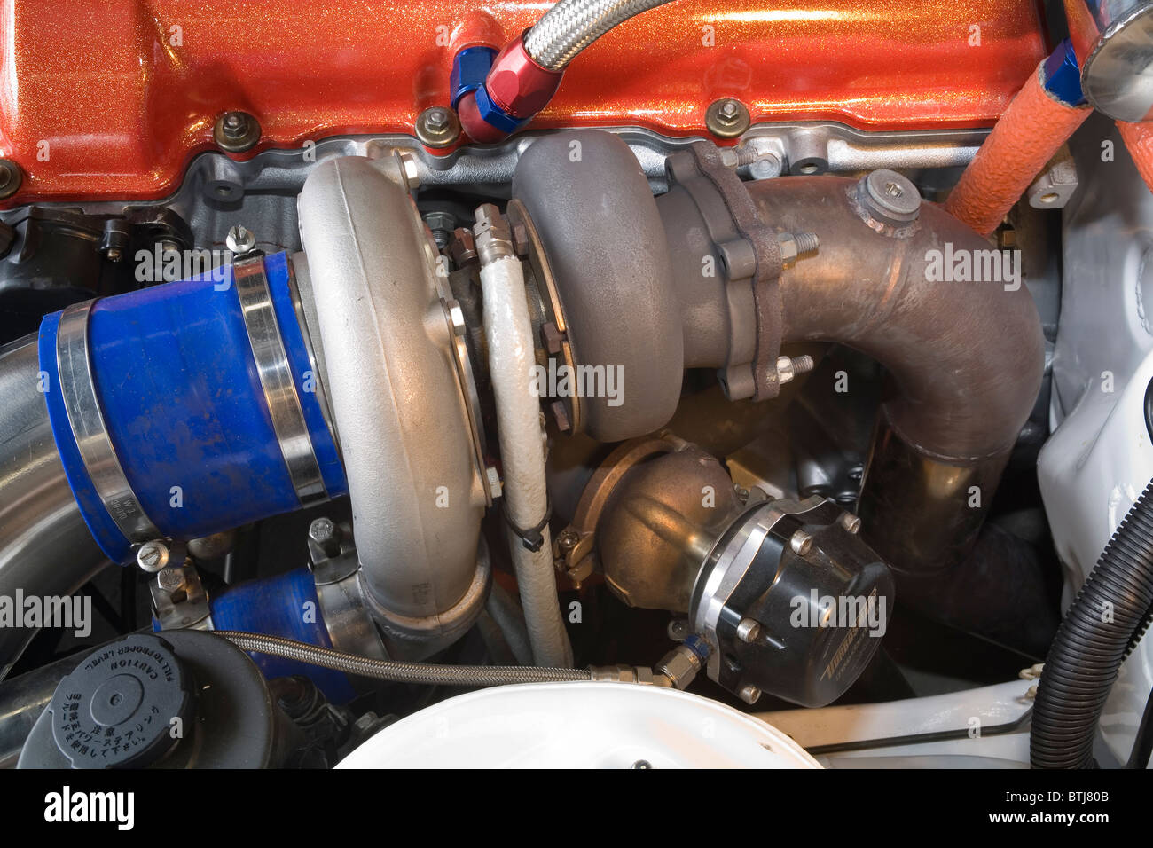 Turbocharger and wastegate attached to a Nissan engine in a modified