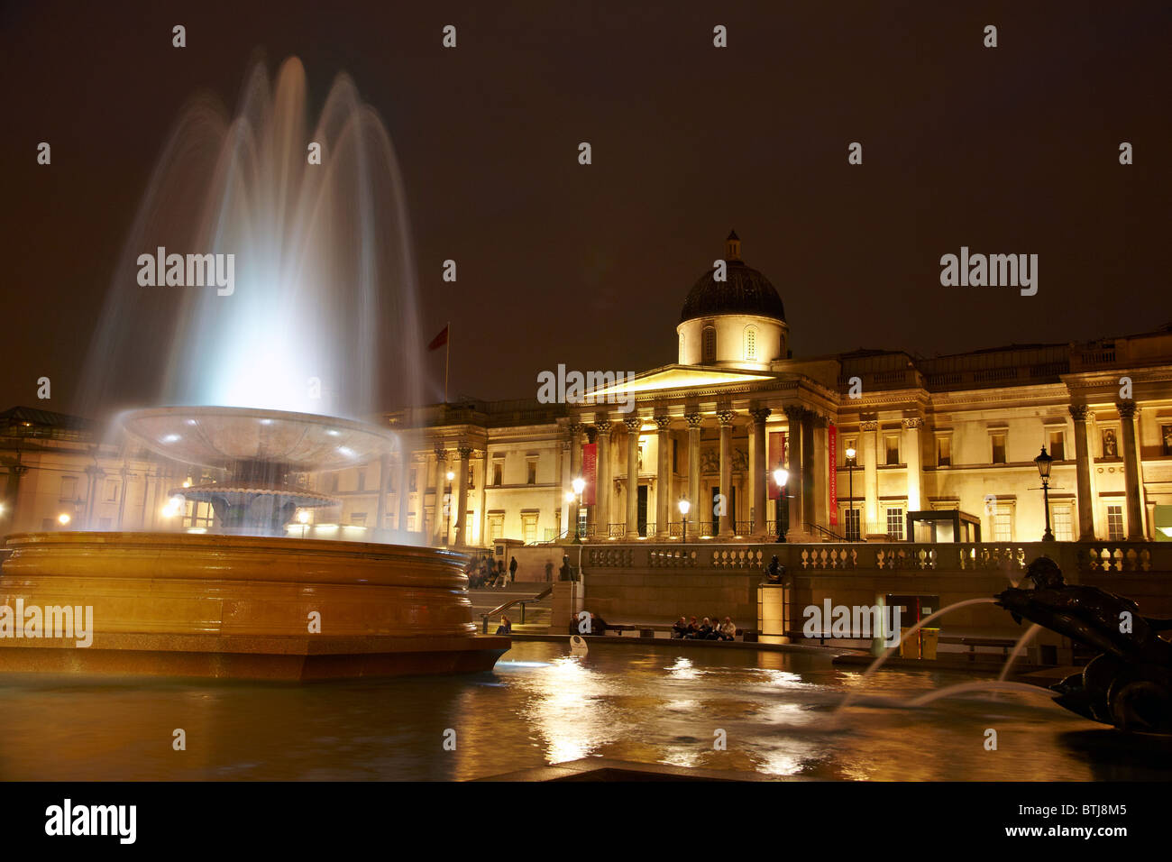 Fountain and The National Gallery at night, Trafalgar Square, London, England, United Kingdom Stock Photo