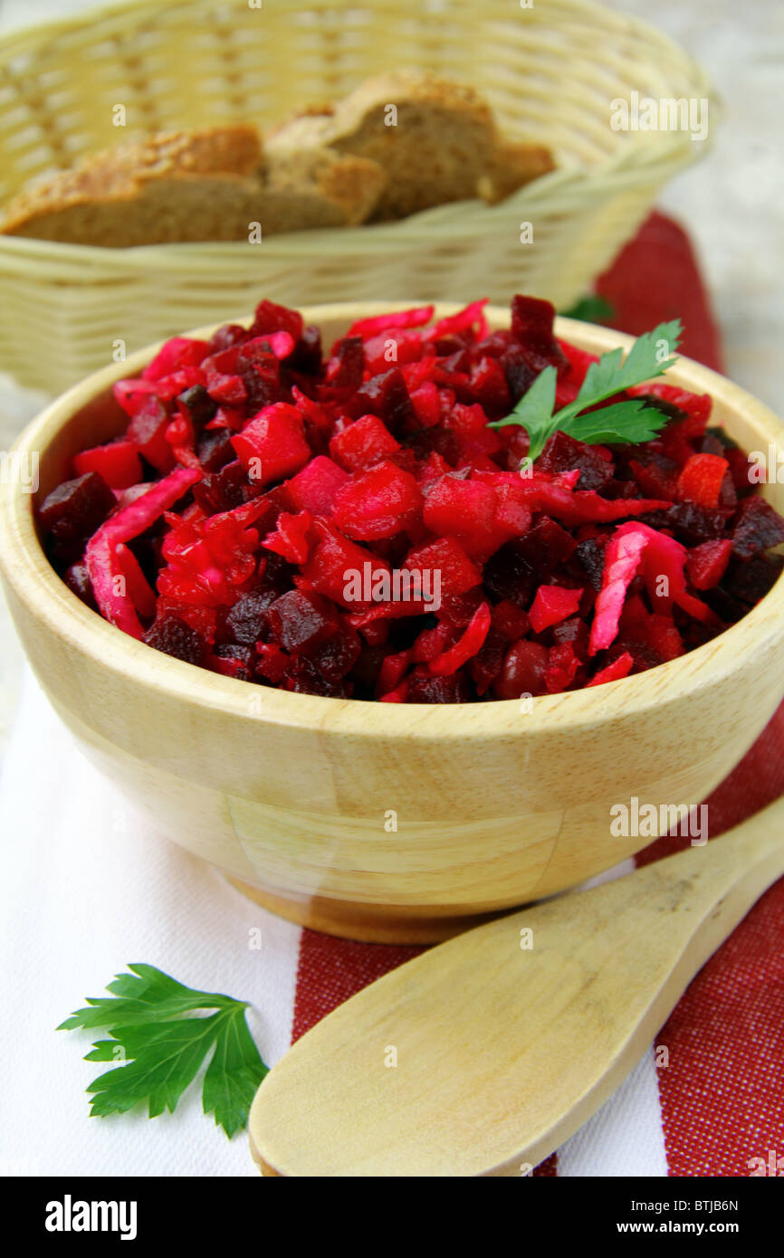 Traditional Russian beet salad in wooden bowl Stock Photo