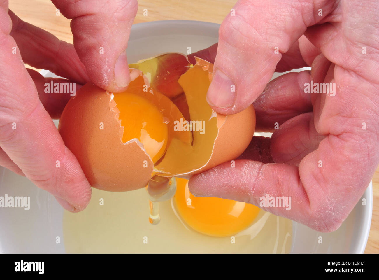 open one organic egg to separate egg yolk Stock Photo Alamy