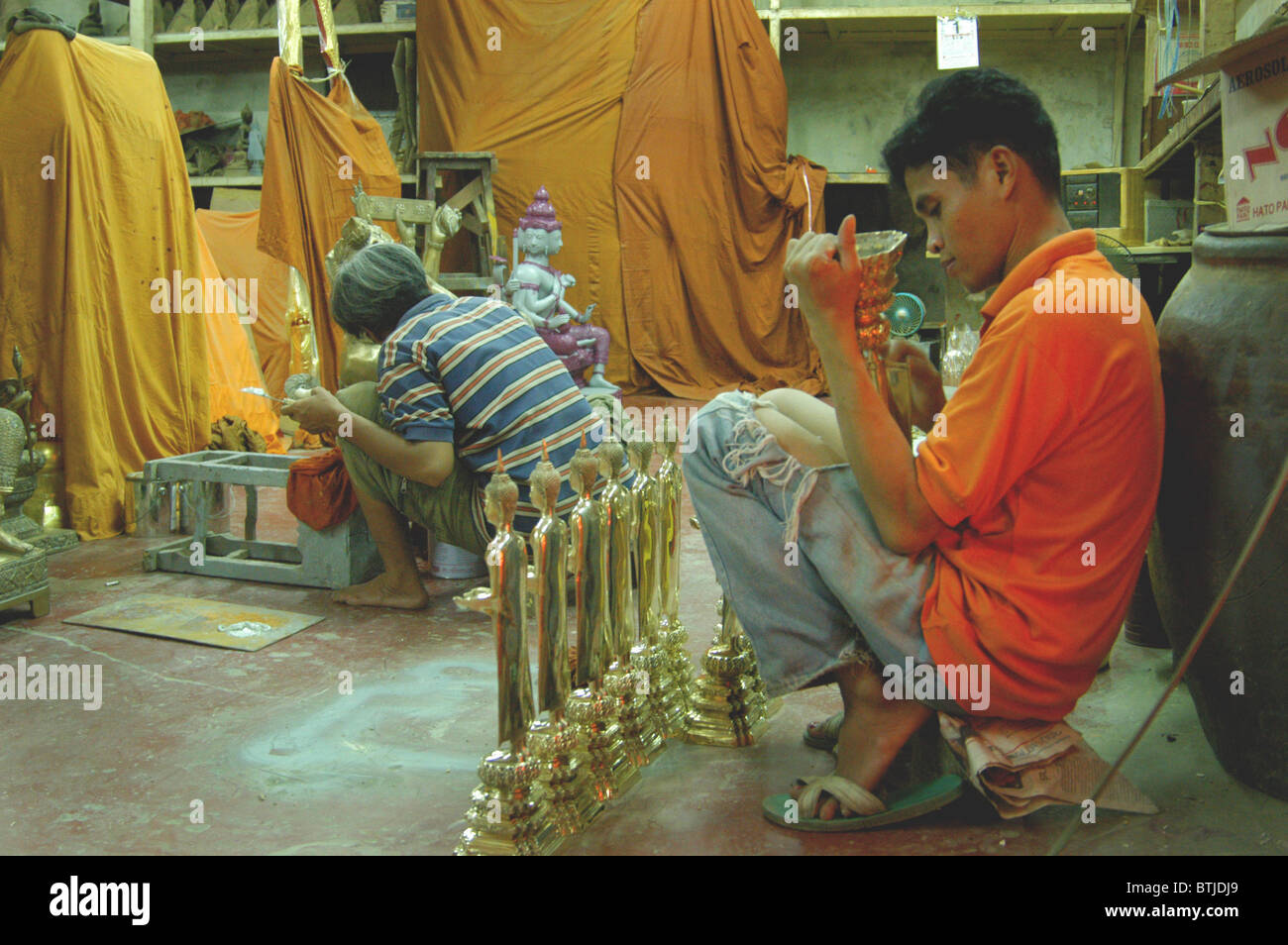 Boy working in a Buddha workshop, bangkok, Thailand. Stock Photo