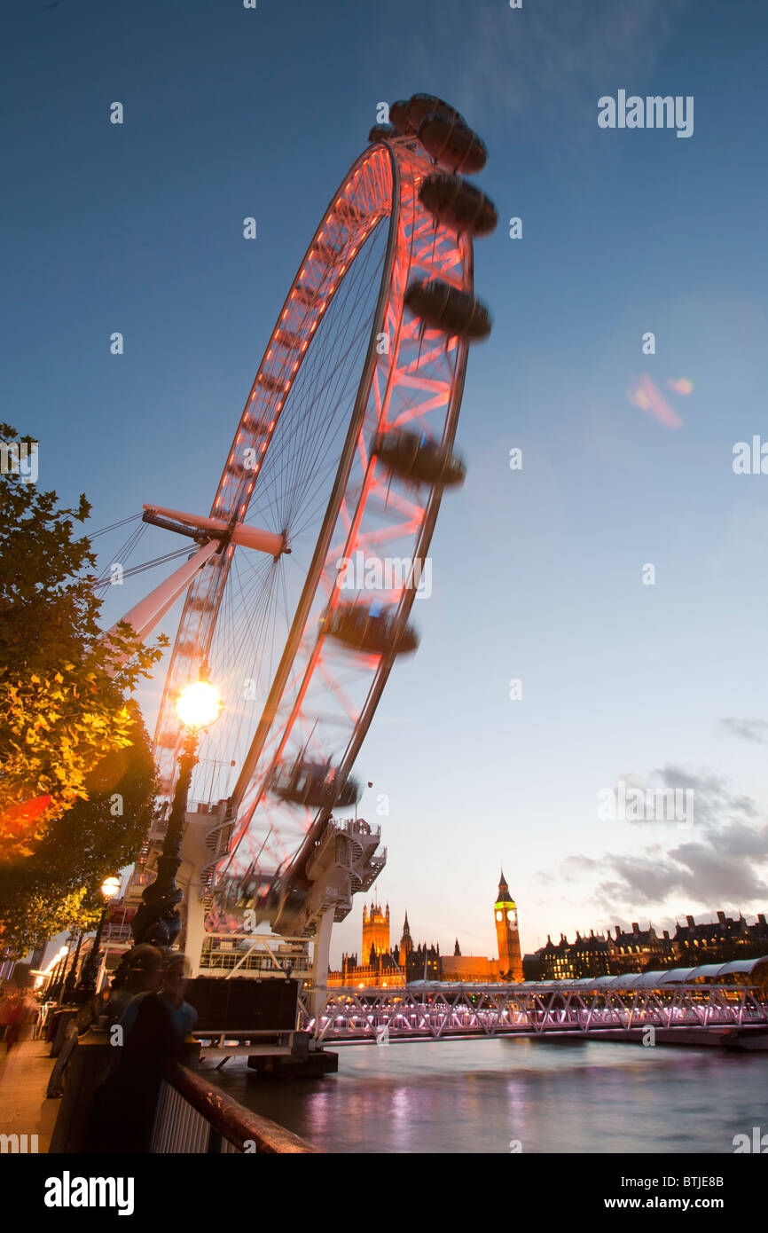 The London Eye and Houses of Parliament on the Thames embankment, London, UK. Stock Photo