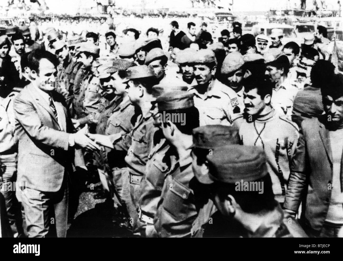 10/19/71--DERAA, SYRIA: Syrian President Hafez Assad (left) shakes hands with Syrian troops near the Syrian-Israeli border. In a Stock Photo