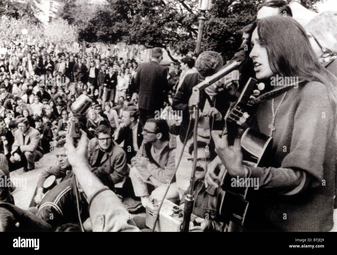 12-2-64 BERKELEY, CALIf.: Folk singer Joan Baez strums her guitar and sings freedom songs during a sit-in at the University of C Stock Photo