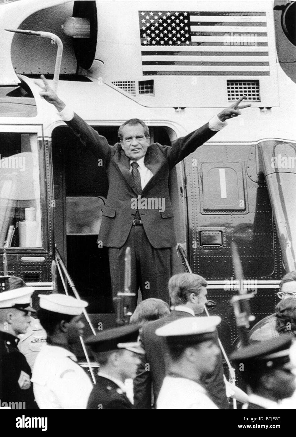 RICHARD NIXON waves with both arms as he bids an emotional farewell to members of his staff after his resignation for the Presid Stock Photo