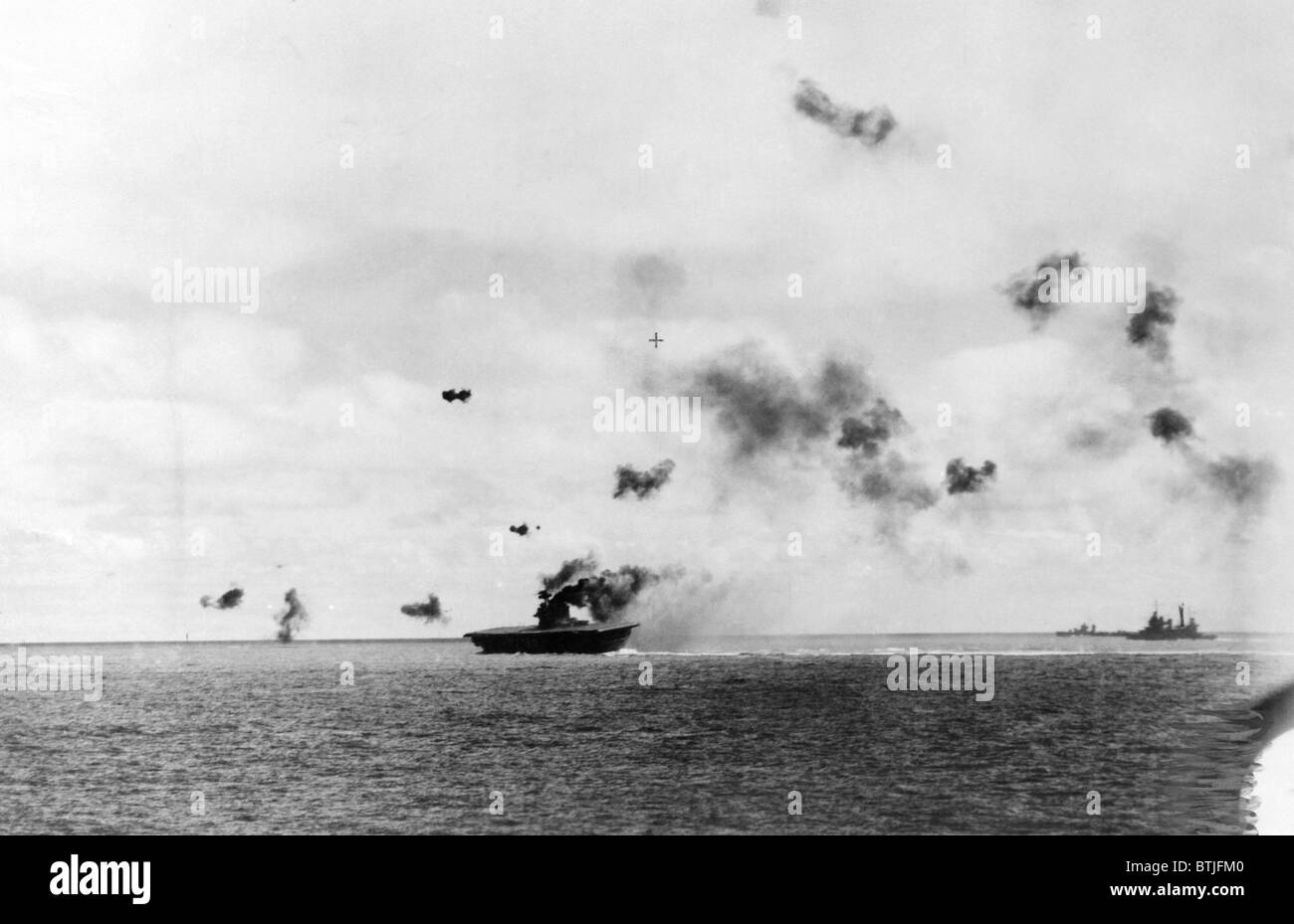 The aircraft carrier USS Yorktown being hit by dive bombers at the Battle of Midway, 1942 Stock Photo