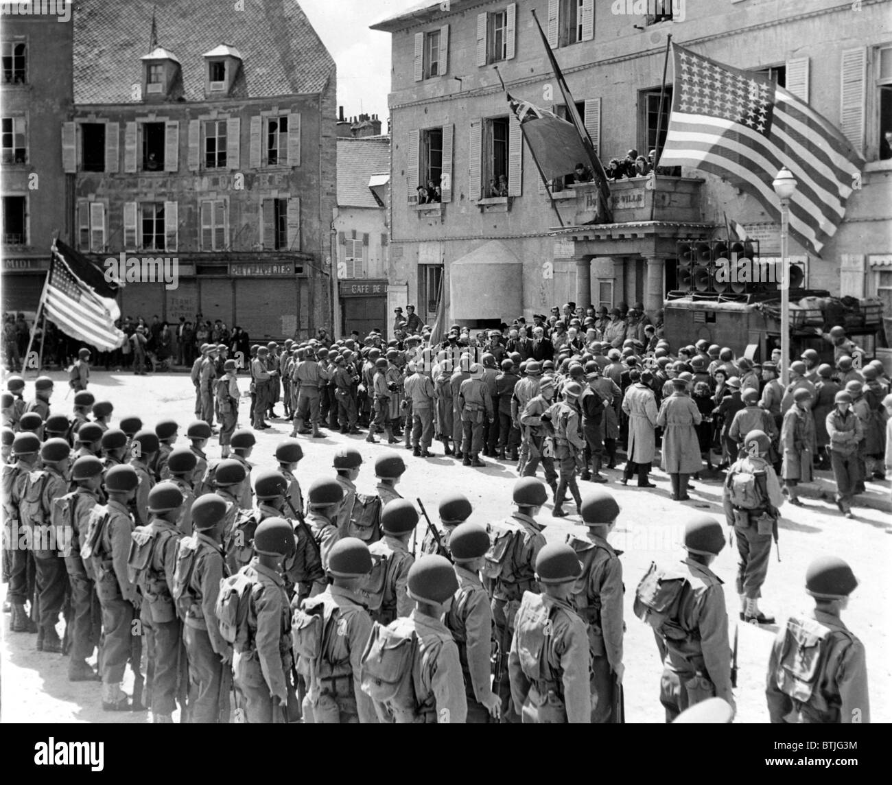 WORLD WAR II, Cherbourg flies under Franch, British and American flags as control of the newly liberated village is returned to Stock Photo