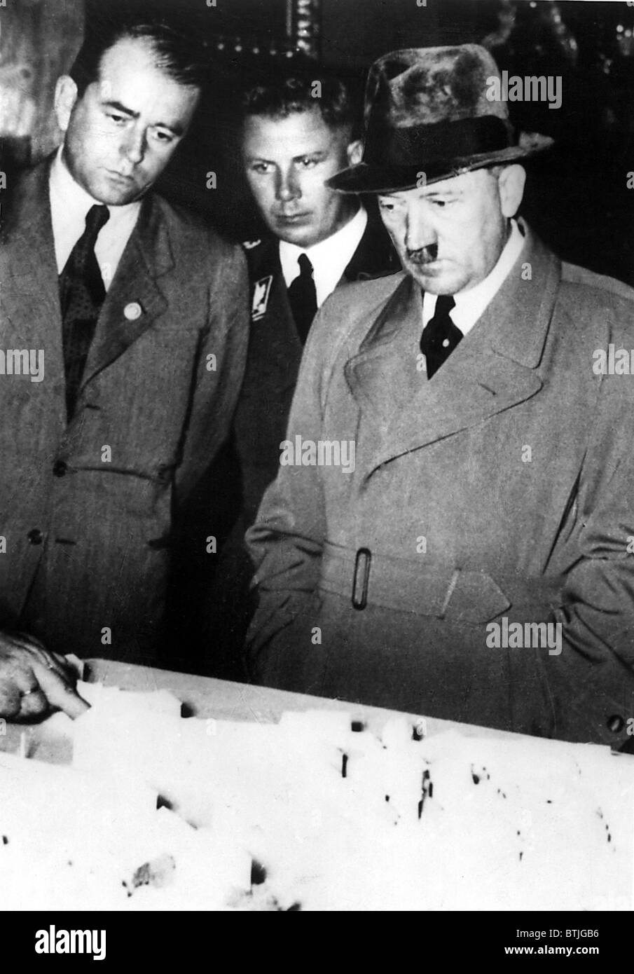 ADOLF HITLER (R), and ALBERT SPEER (L), examine an architectural model, during WWII, 1940s. Everett/CSU Archives. Stock Photo