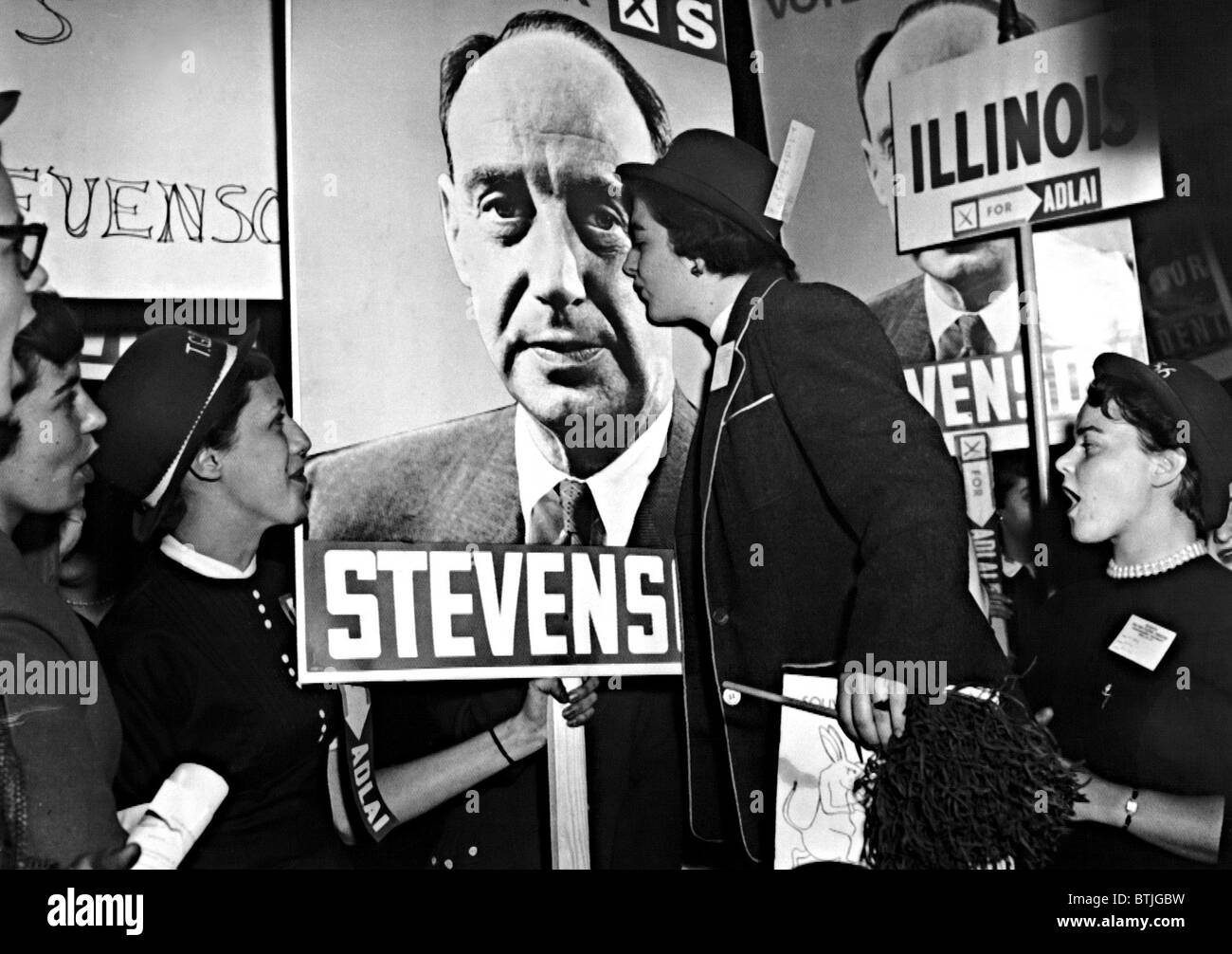 ADLAI STEVENSON, presidential candidate, is pictured on this campaign sign, which is being kissed by Betty Lonn and other Northw Stock Photo