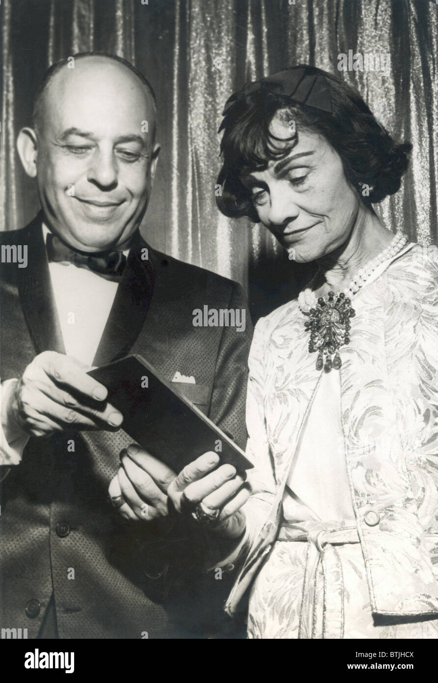 GABRIELLE 'COCO' CHANEL, being presented an award, c. early 1960s (date stamped on the press photo is 1965) Stock Photo