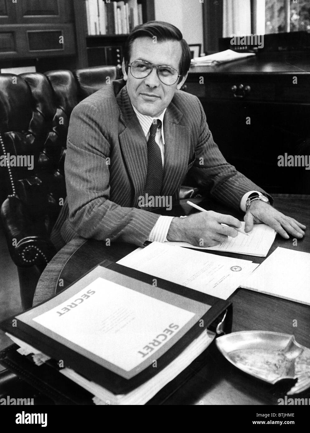 DONALD RUMSFELD, working in his office after the Senate confirmed his nomination to Secretary of Defense, 1975 Stock Photo