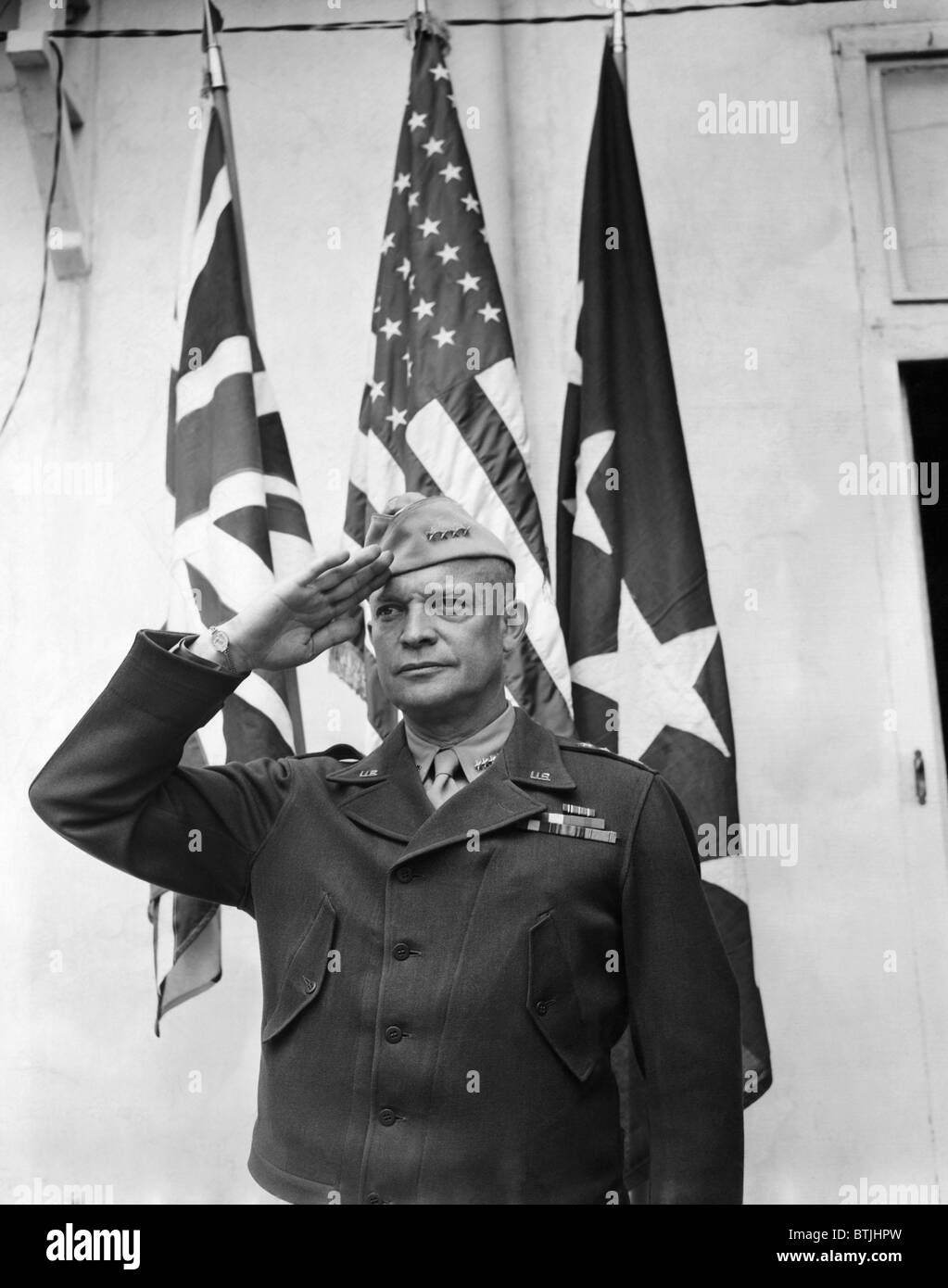 General Dwight D. Eisenhower saltuing the British, American, and the General's Flags, May 8, 1943. Courtesy: CSU Archives/Everet Stock Photo