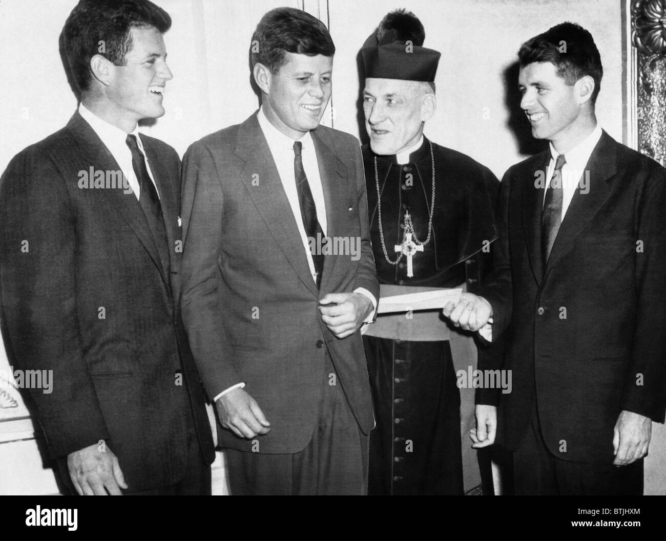From left, Edward Kennedy, John Kennedy, Archbishop Cushing, Robert Kennedy, with check from Joseph P. Kennedy Foundation to the Stock Photo
