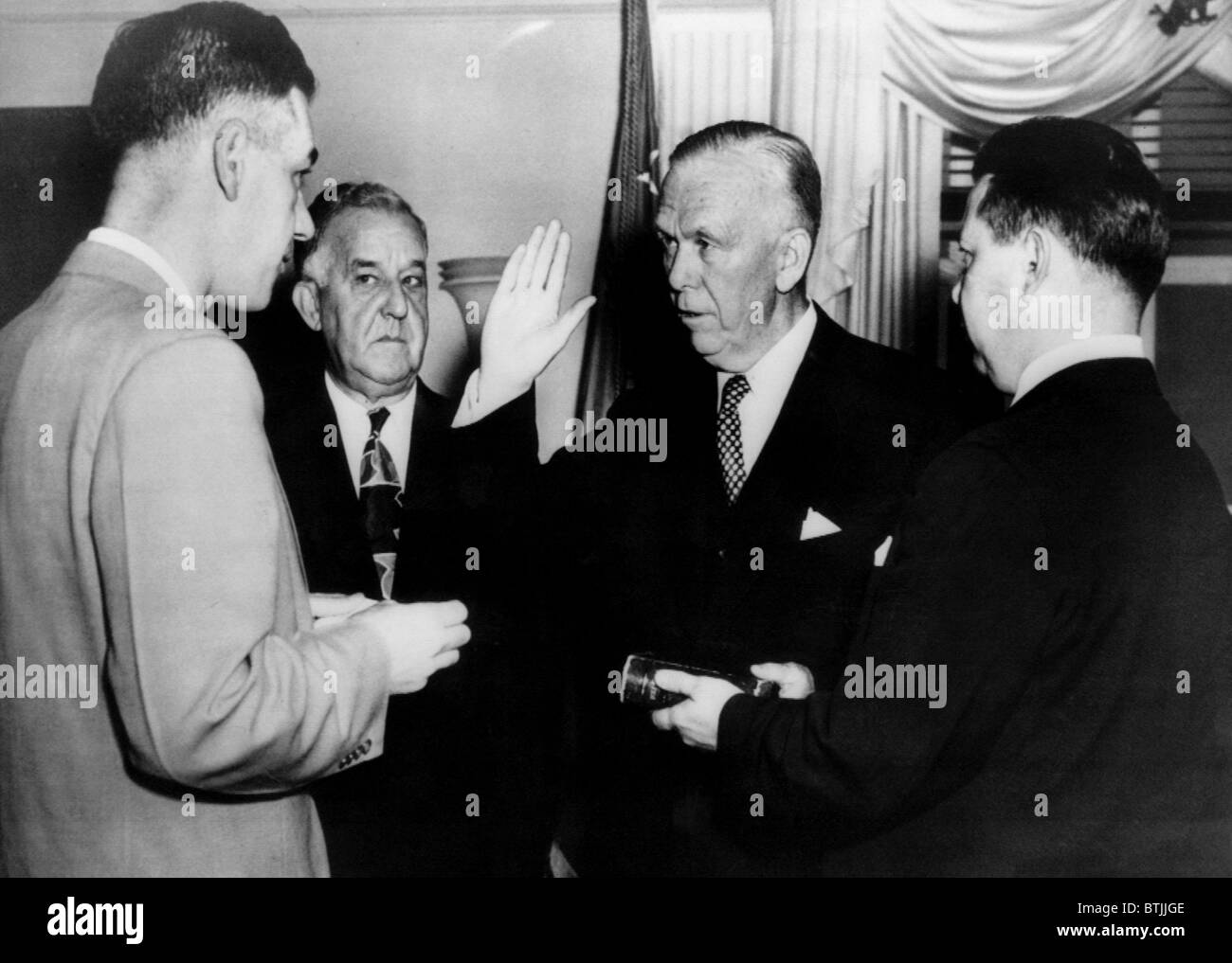 General George C. Marshall sworn in as Secretary of Defense. From left: Felix Larkin (General Counsel, Office of the Secretary o Stock Photo