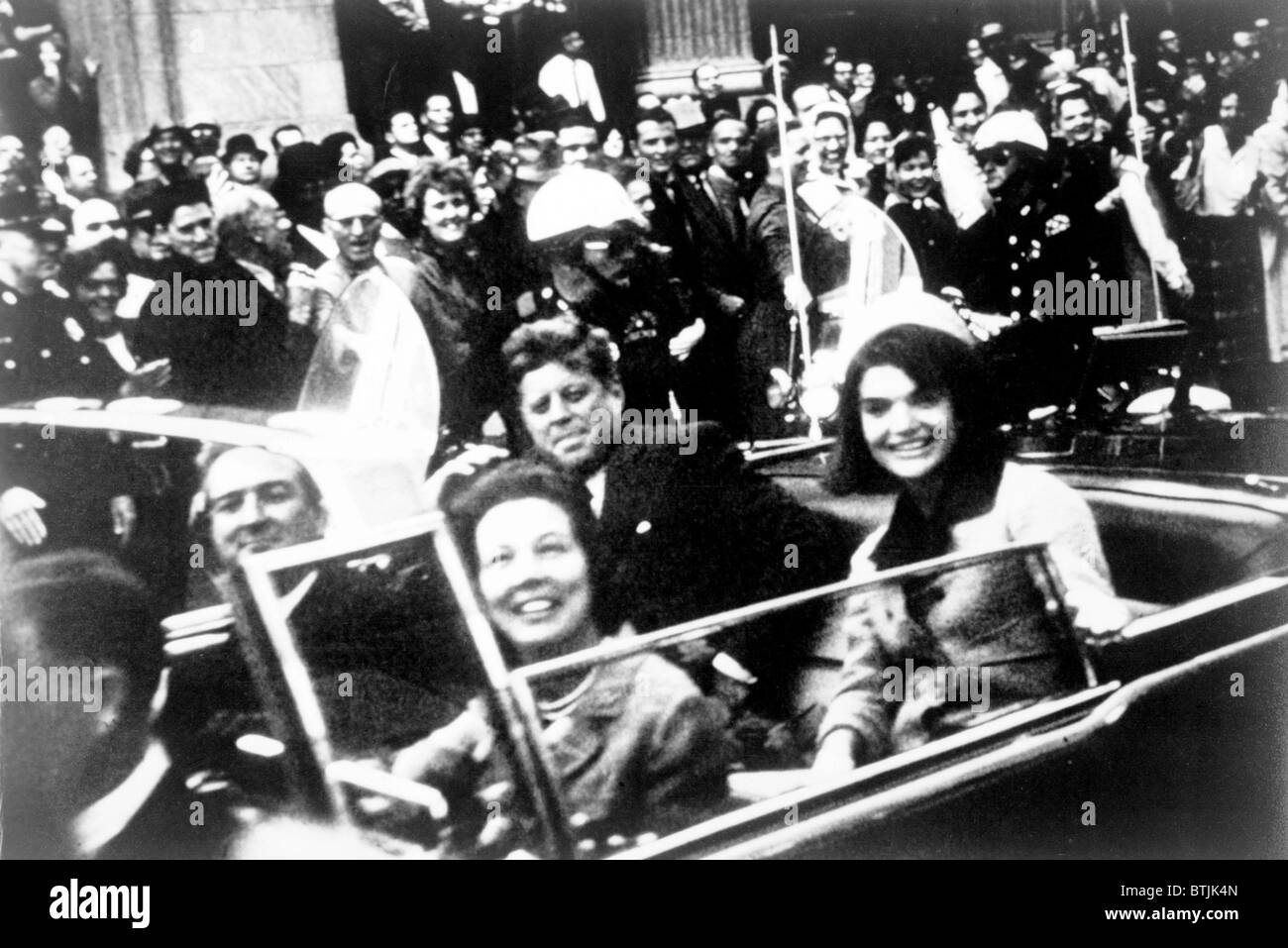 John F. Kennedy motorcade, Dallas, Texas. Photograph shows a close-up view of President and Mrs. Kennedy and Texas Governor John Connally and his wife. Victor Hugo King, photographer. November 22, 1963 Stock Photo