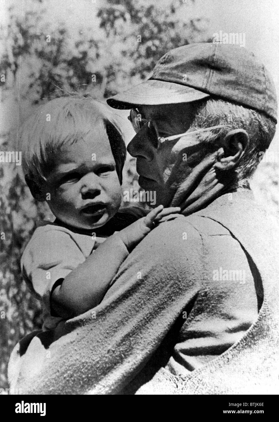 Henry Miller holding his son Tony, circa 1950 Stock Photo