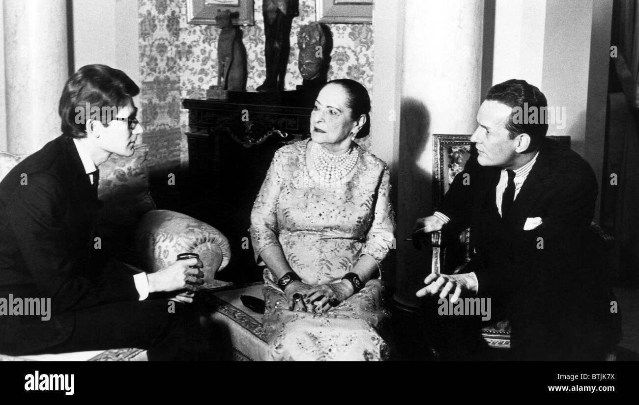 French fashion designer Yves Saint Laurent, Helena Rubinstein (wearing a YSL  design), and Patrick O'Higgins (author of the biogr Stock Photo - Alamy
