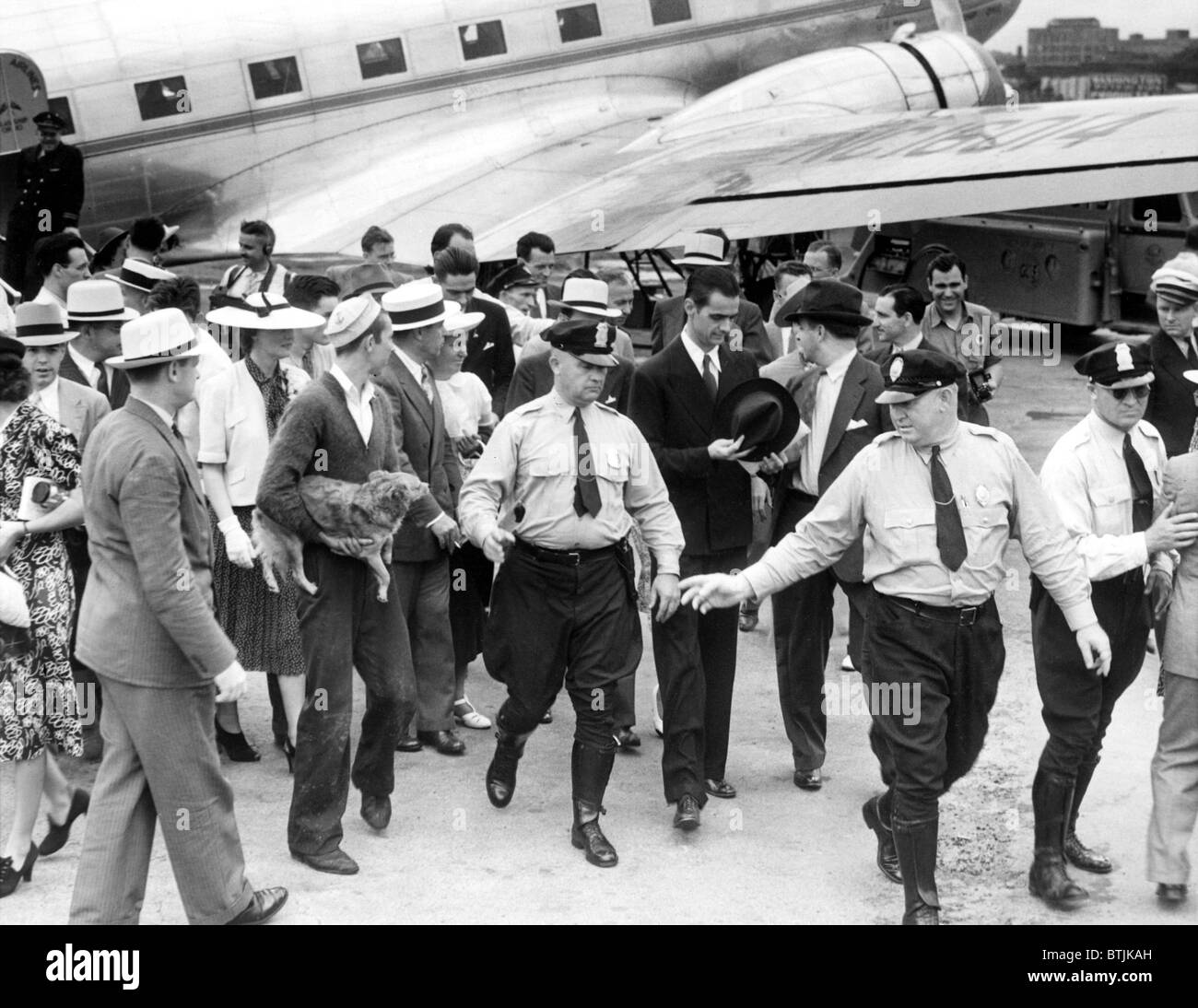 Howard Hughes leaves his plane in Washington, DC after his round the ...