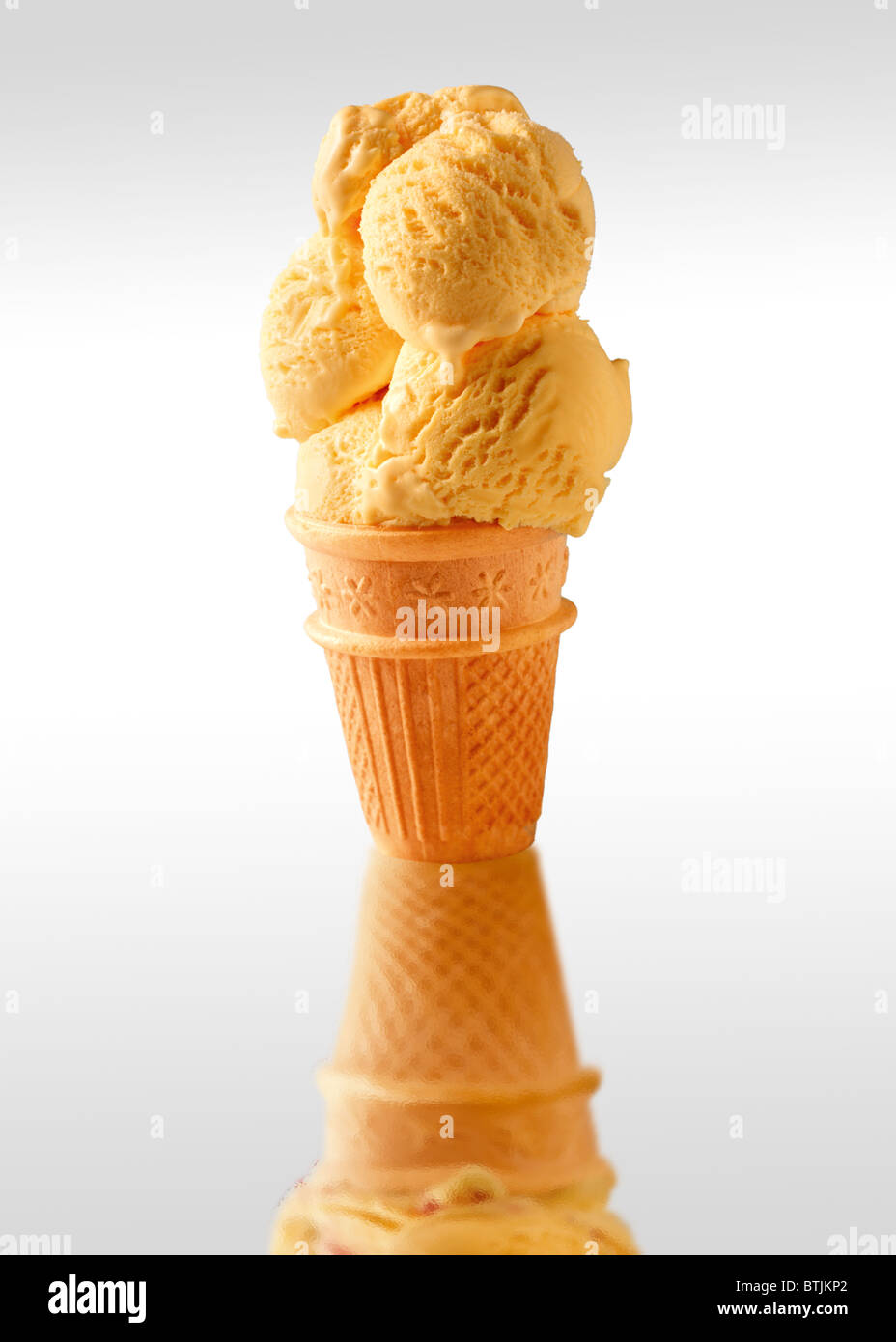 Traditional Cornish vanilla Ice cream scoops served cold in a wafer cone Stock Photo