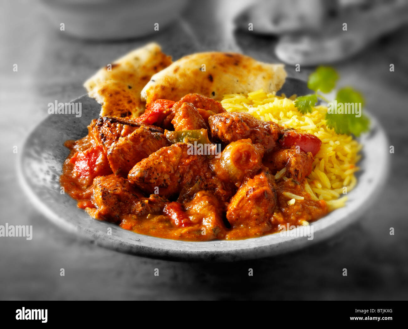 Indian food chicken jalfrezi curry in balti dish decoration set of  vegetables Stock Photo - Alamy