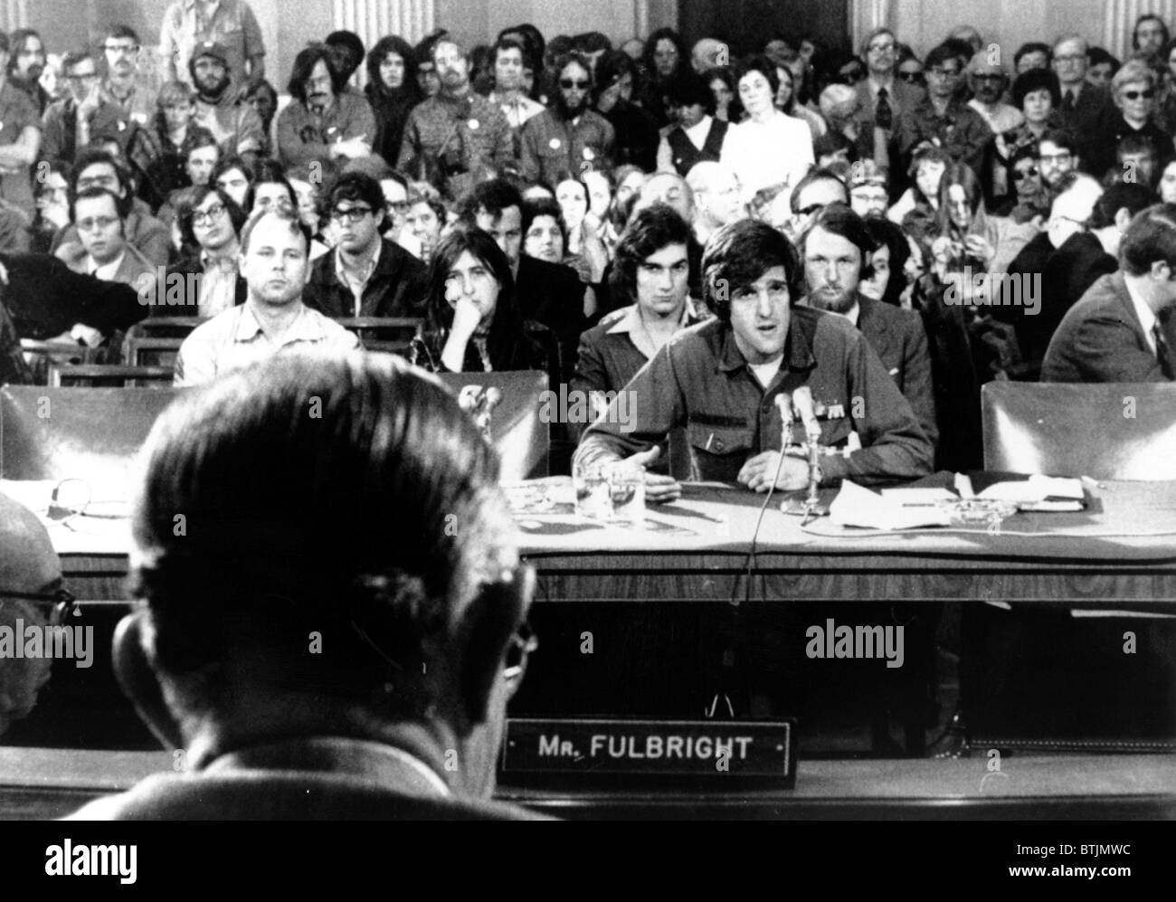 John Kerry giving testimony against the war to Senator J. William Fulbright (back to camera), 4/22/1971 Stock Photo