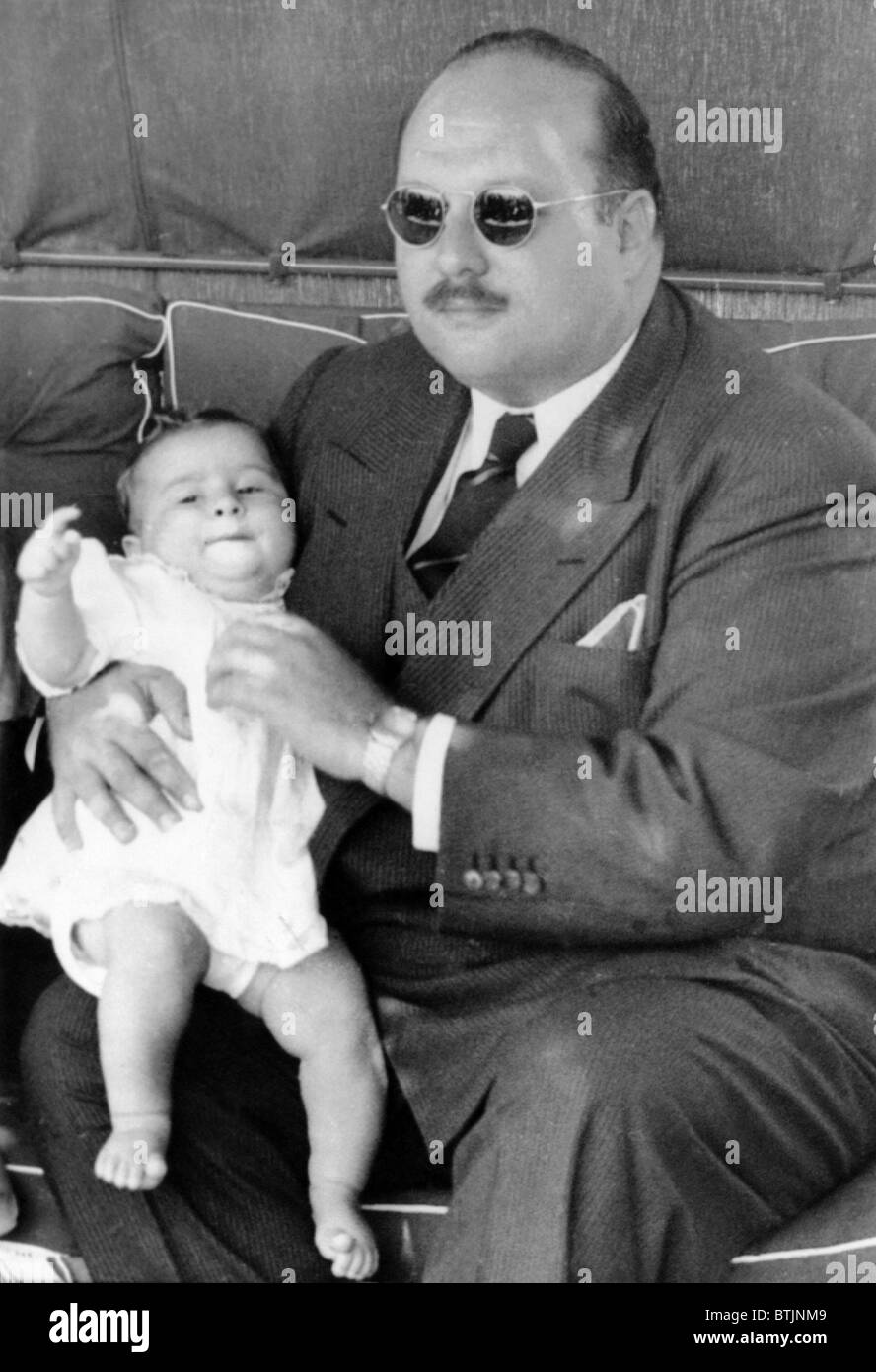 Former King Farouk of Egypt holding baby Prince Ahmed Fouad, Italy, August 2, 1952. Stock Photo