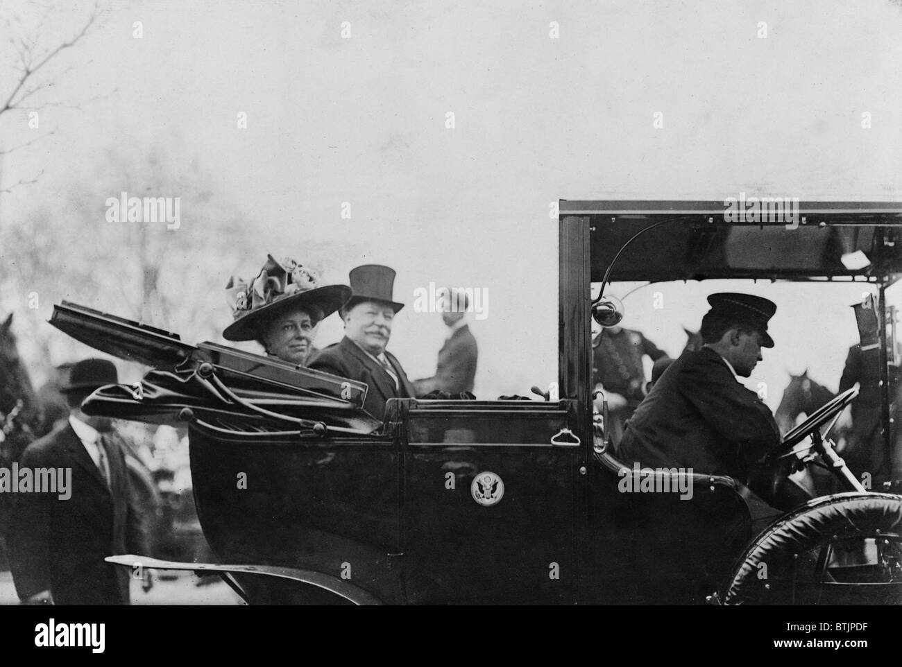 President William Taft (1857-1930) and First Lady, Helen Taft, seated in the back of an open convertible automobile in 1909. Stock Photo