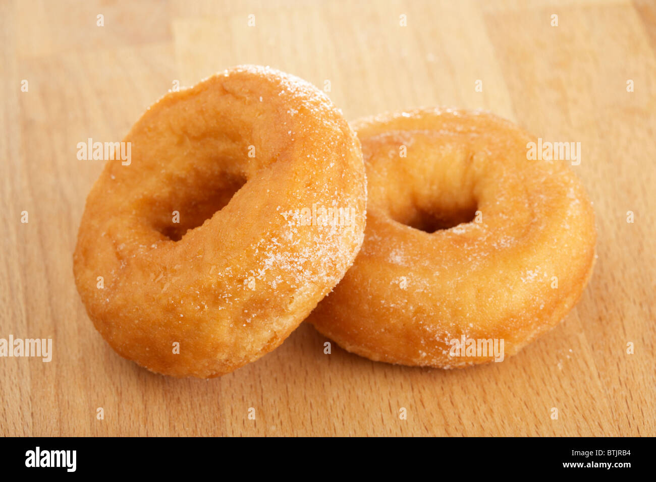 simple plain lightly sugar coated donuts known as gravy rings Stock Photo