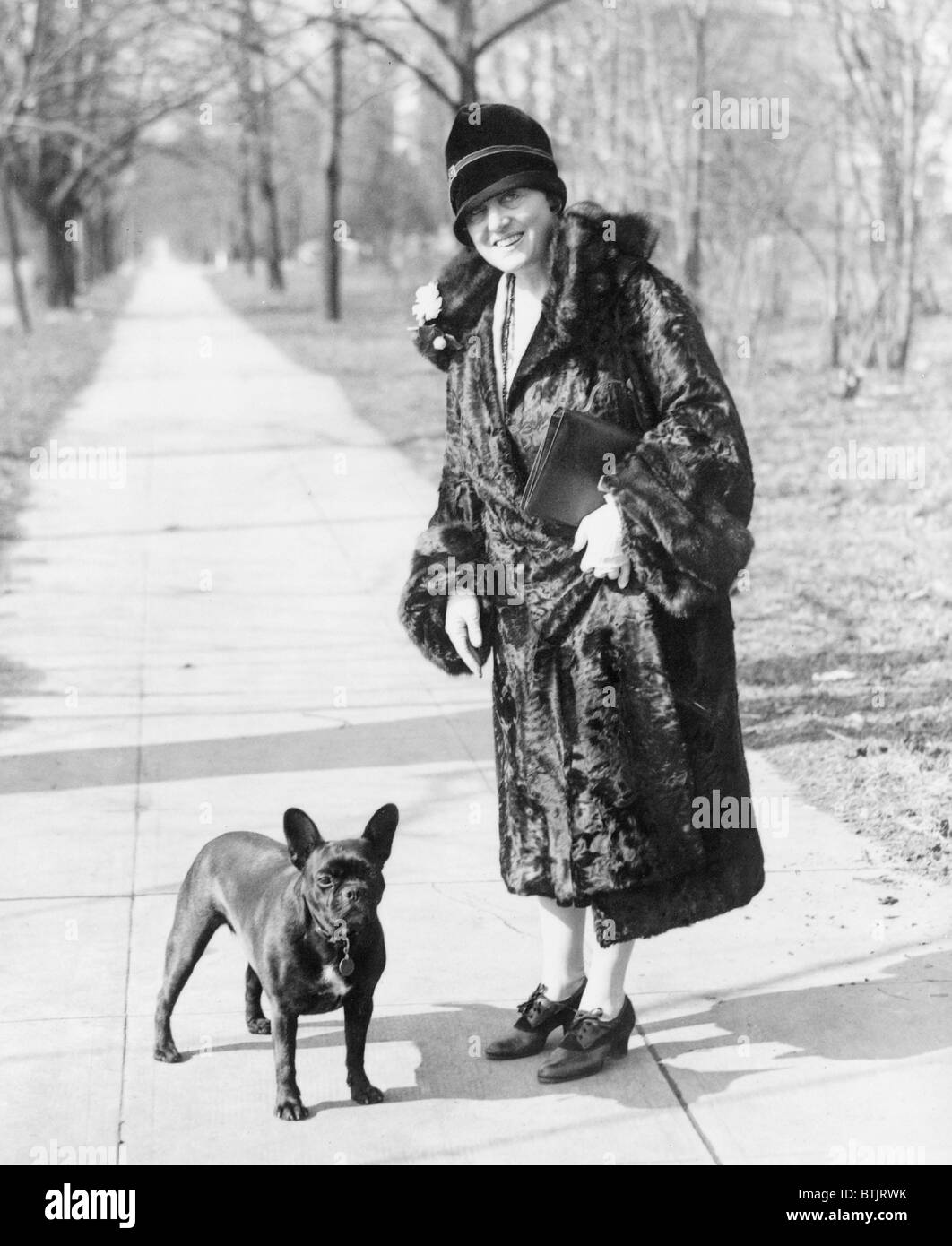 Mary Roberts Rinehart, (1876-1858), popular American novelist and playwright of mystery tales, whose career spanned over 40 years. Press photo snapped while out for a stroll with her favorite pet. Stock Photo