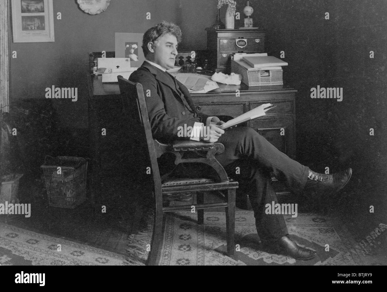 David Belasco, (1853-1931), American theatrical producer and playwright known for inventively realistic stage productions, seated in his office, ca, 1910 Stock Photo