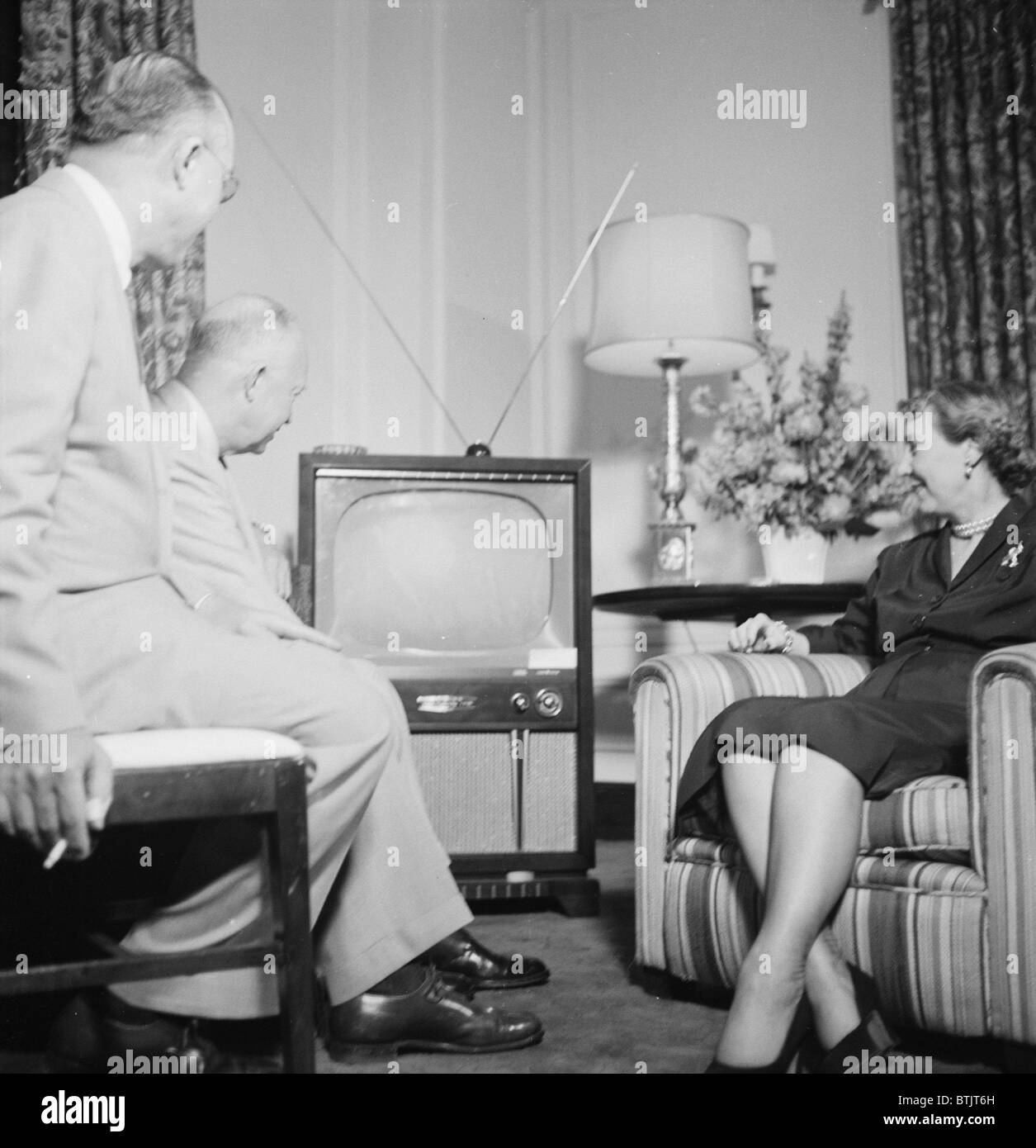 Future President Dwight D. Eisenhower (back left), and future First Lady Mamie Eisenhower, watch the Republican National Convention on television, photograph by Thomas J. O'Halloran, July, 1952. Stock Photo