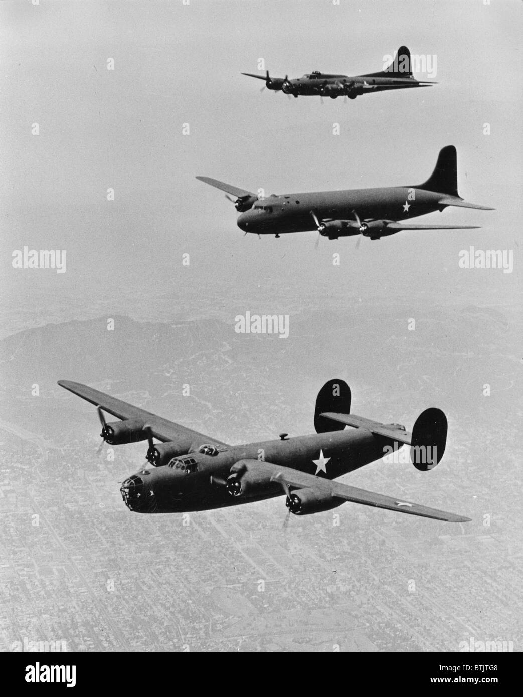 World War II, United States planes in echelon formation, from the top: Boeing Flying Fortress B17, Douglas Transport, Consolidated Liberator B-24, circa 1942. Stock Photo