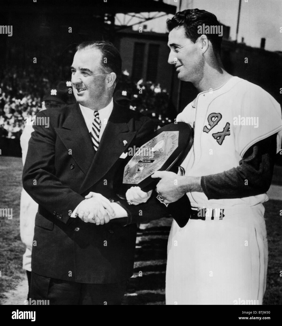Baseball Commissioner Albert B. Chandler, presents the Most Valuable Player award to Ted Williams of the Boston Red Sox, April 1 Stock Photo