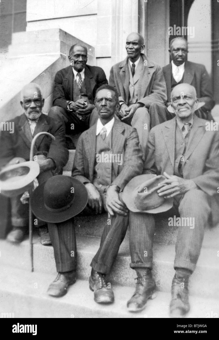 African American exslaves sitting, original caption 'Attendants at
