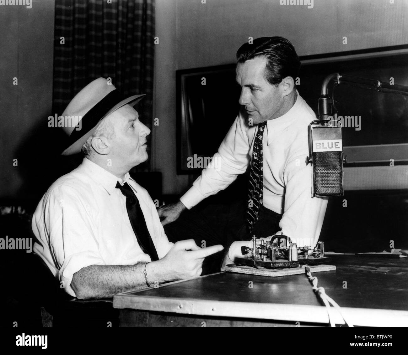 American radio commentators Walter Winchell (left), and Jimmy Fidler (right), just before going on the air for NBC's BLUE networ Stock Photo
