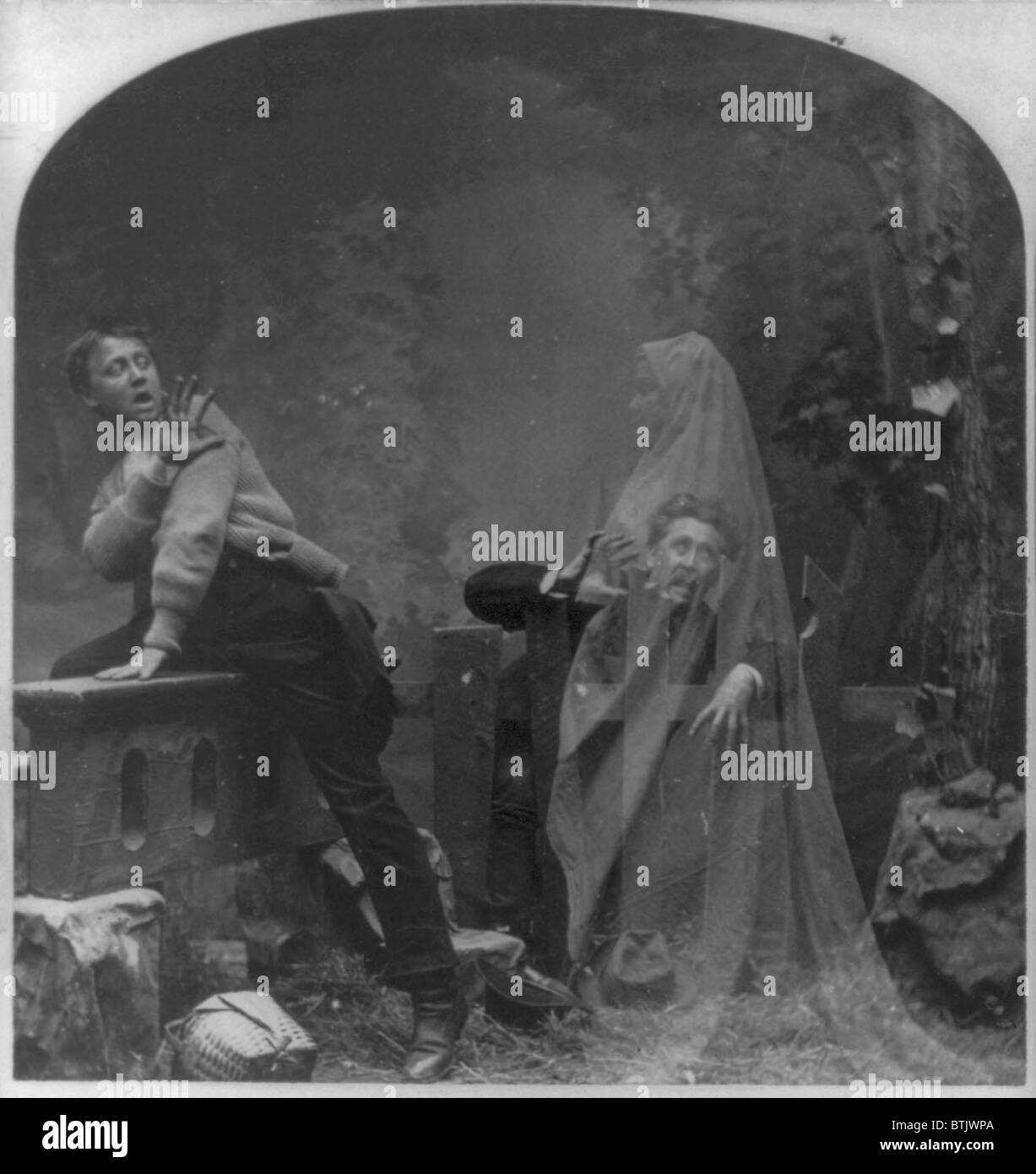 Stereograph shows a ghost scaring man and boy, a posed studio scene, original title: 'The Haunted Lane', photograph by Melander, 1889. Stock Photo