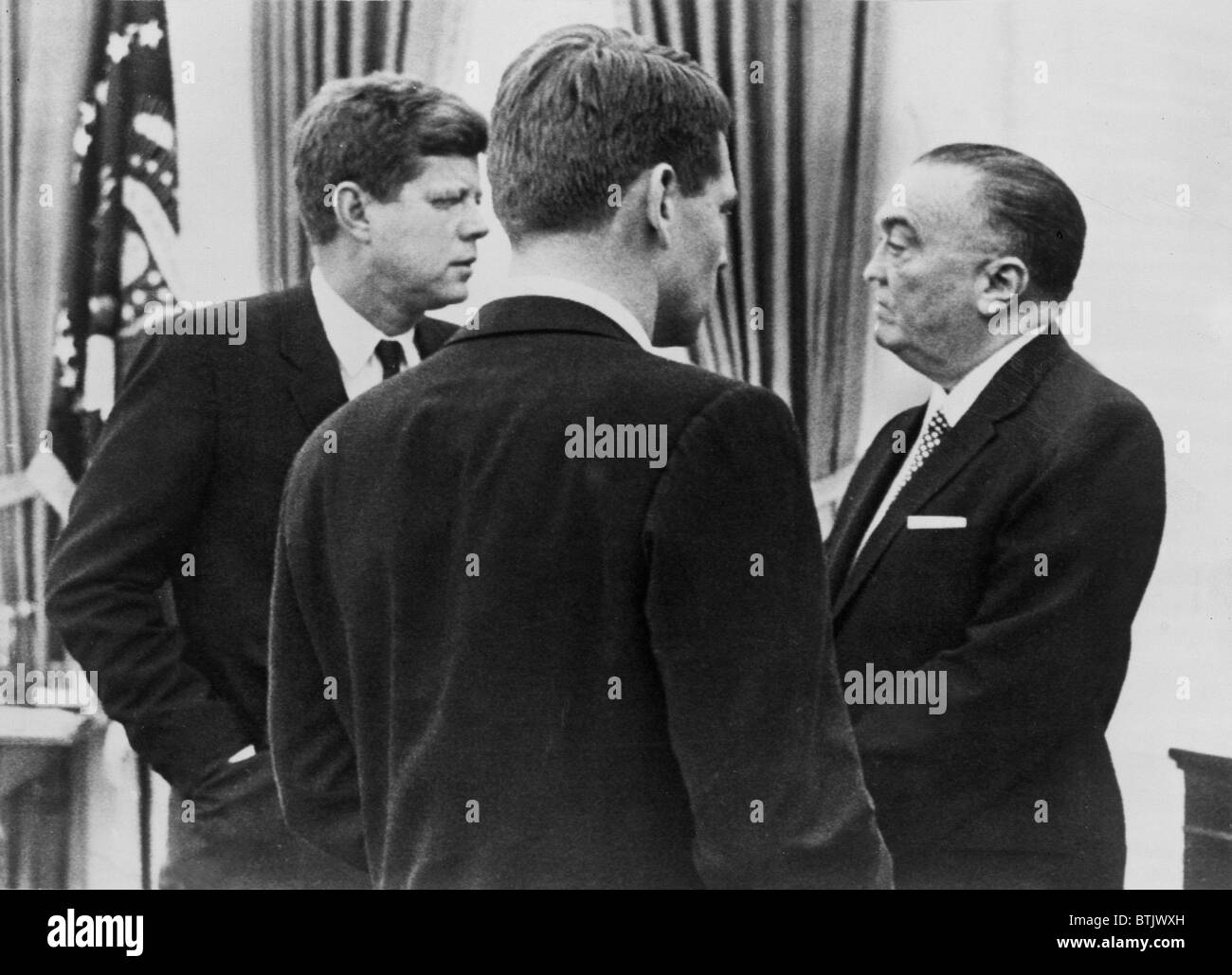 President John F. Kennedy, Attorney General Robert F. Kennedy, and FBI director J. Edgar Hoover, speak about increased wiretapping, February 24, 1961. Stock Photo
