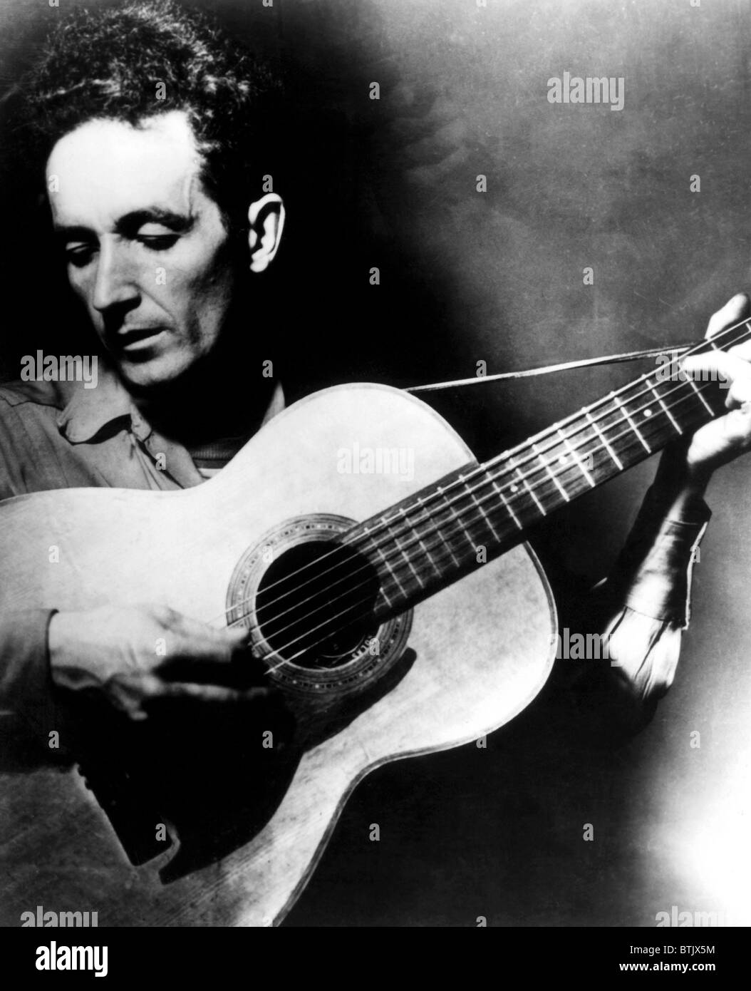 Folk singer Woody Guthrie, ca.1950s. Courtesy CSU Archives/Everett Collection. Stock Photo
