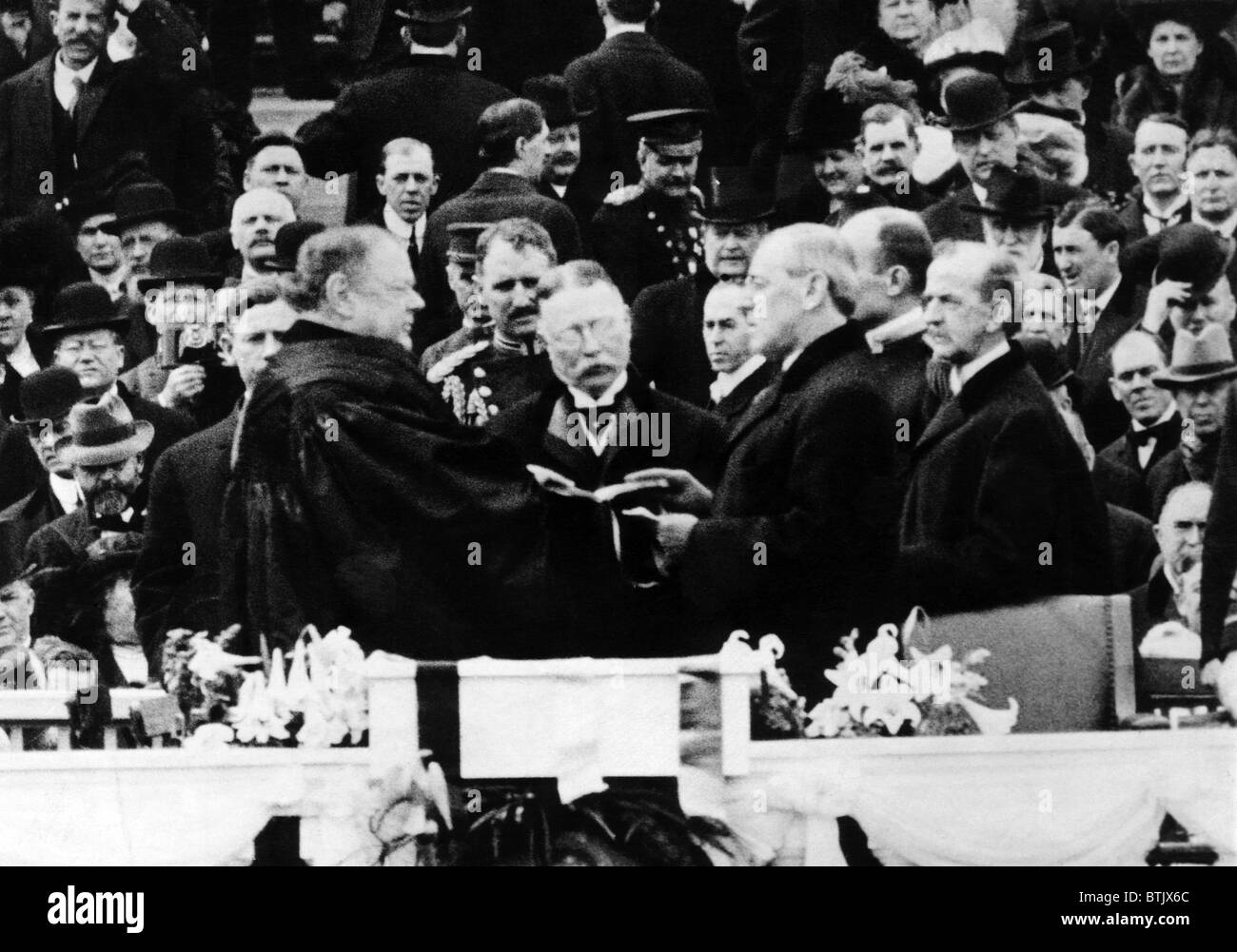 President Elect Woodrow Wilson (center right), taking the oath of
