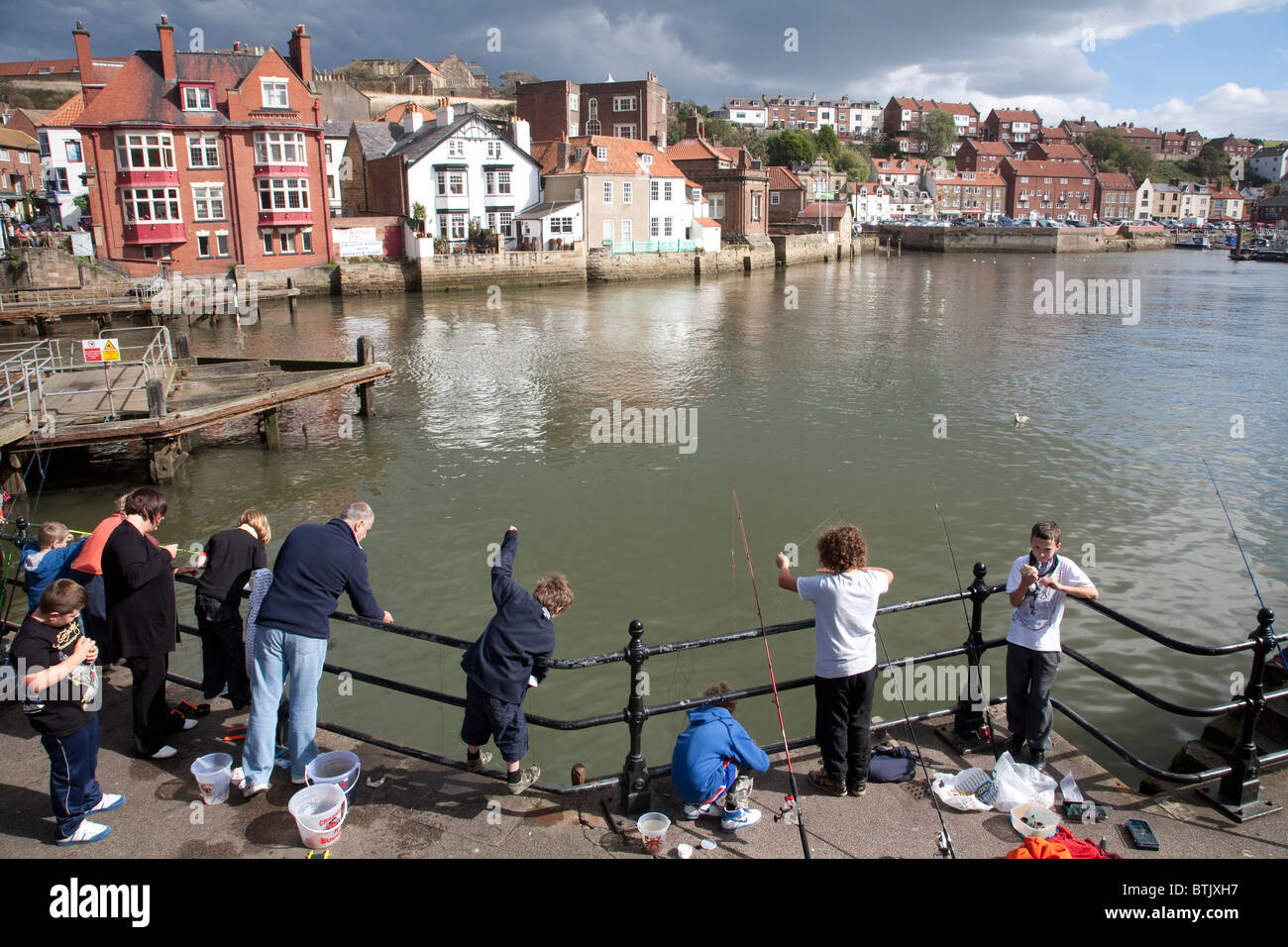 Families fishing at the mouth of the River Esk, Whitby, North Yorkshire. Photo:Jeff Gilbert