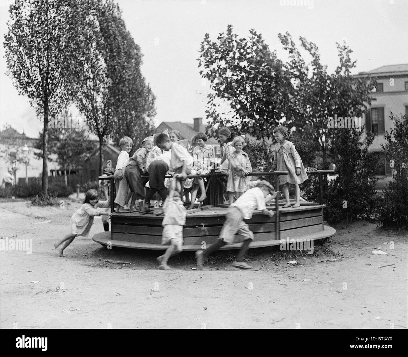 Children playing at a playground, circa 1918-1920. Stock Photo
