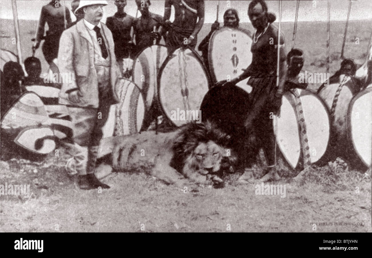 President Theodore Roosevelt (front left), with native beaters and lion killed with spear, original title: 'President Theodore Roosevelt in Africa, Lion hunt on Athi Plains', photograph 1910. Stock Photo