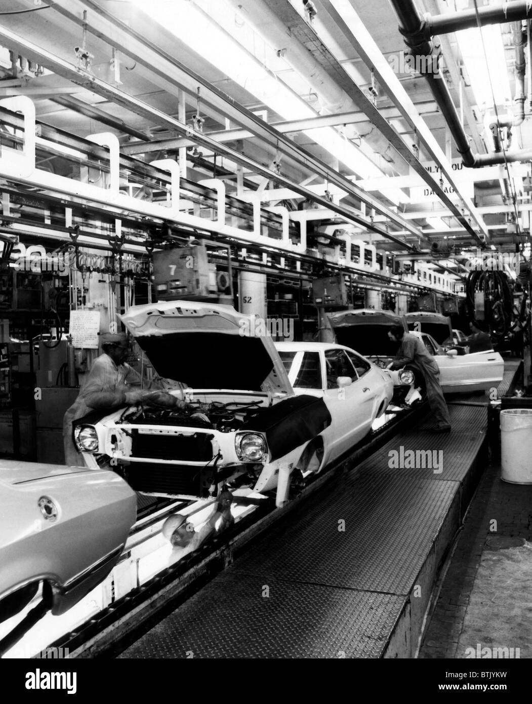 Workers assemble Ford Mustangs at the plant in Dearborn, Michigan, 1976