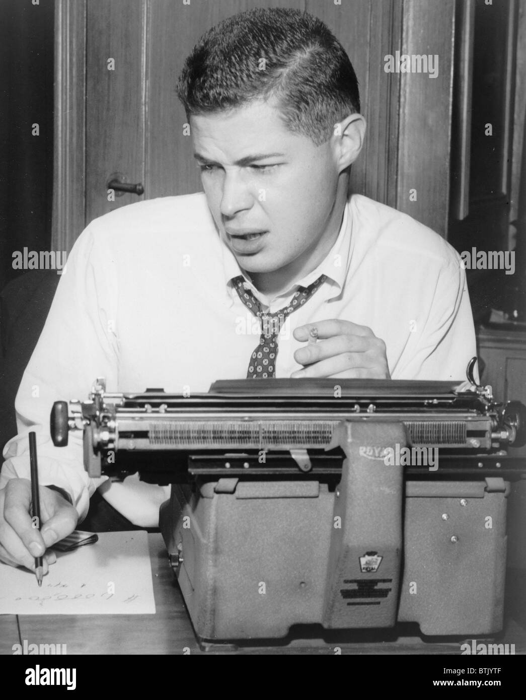 George Axelrod (1922-2003), playwright and screenwriter, seated at typewriter. Axelrod 's plays include, SEVEN YEAR ITCH and WILL SUCCESS SPOIL ROCK HUNTER? He wrote screenplays for BUS STOP, BREAKFAST AY TIFFANY'S, THE MANCHURIAN CANDIDATE, and LORD LOVE A DUCK. Stock Photo