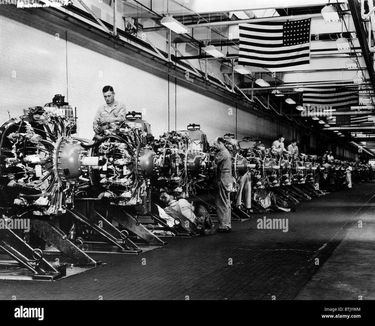 Men prepare engines for the B-24 Liberator bomber airplane at a Buick plant, 1943. Courtesy: CSU Archives/Everett Collection Stock Photo