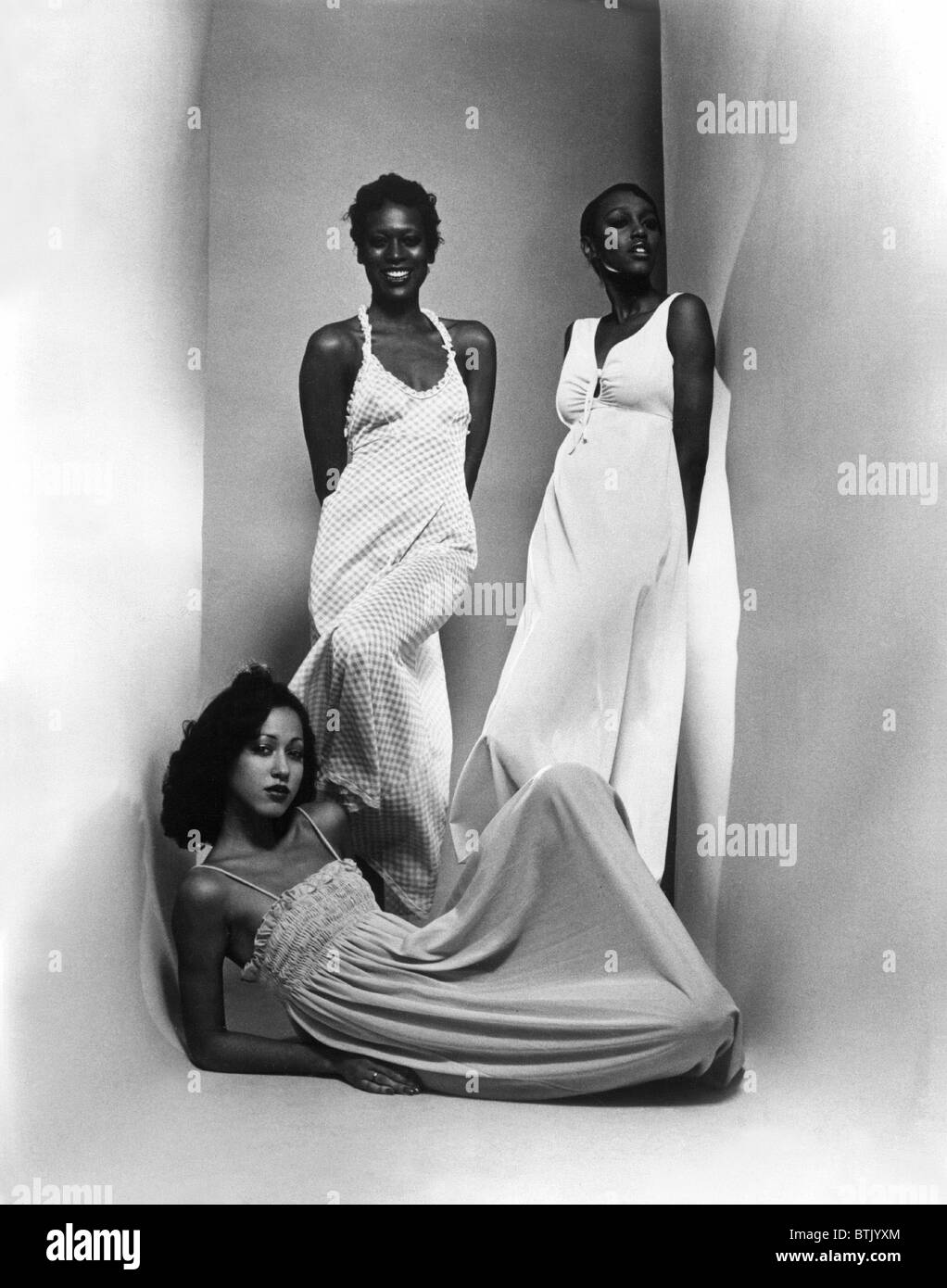 Three models sport maxi-dresses with empire waistlines, 1973. Stock Photo