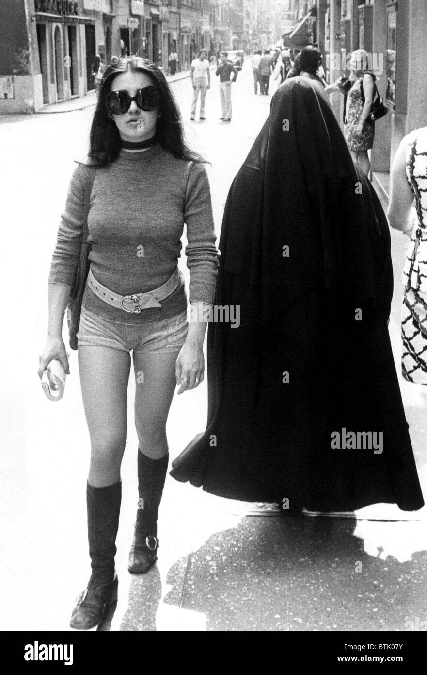 Young girl in  hot pants and a nun on the Via Frattina, Rome Italy, 7/19/71 Stock Photo